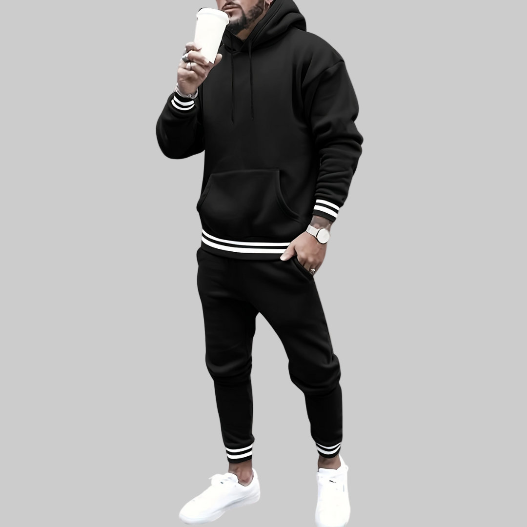 Person wearing a black tracksuit with white stripes on a white background