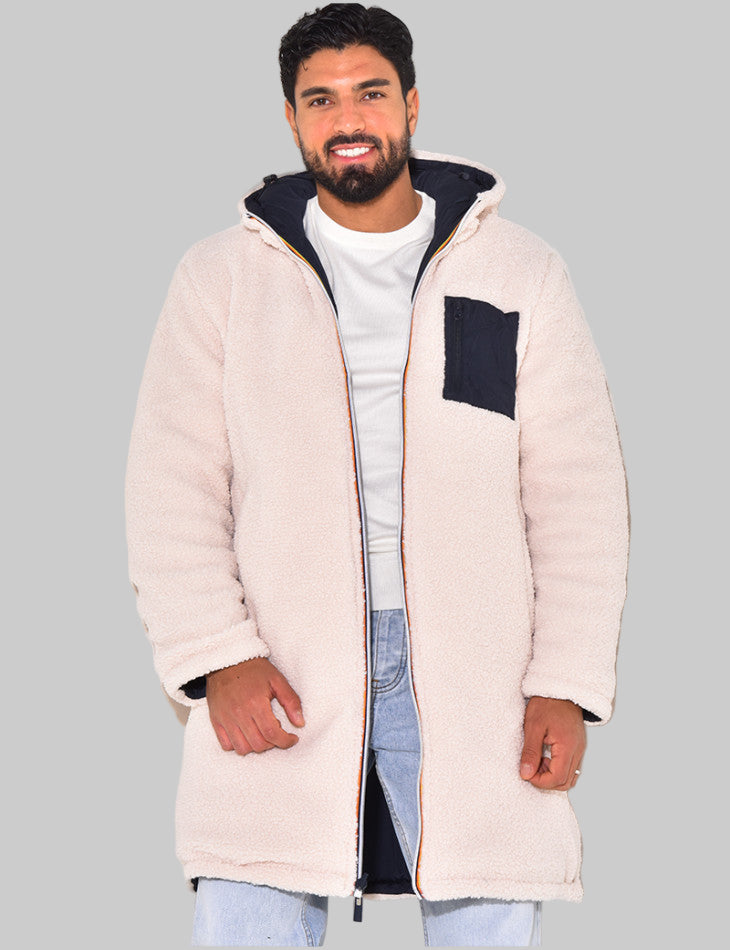 Man wearing a long beige coat with a hood on a white background